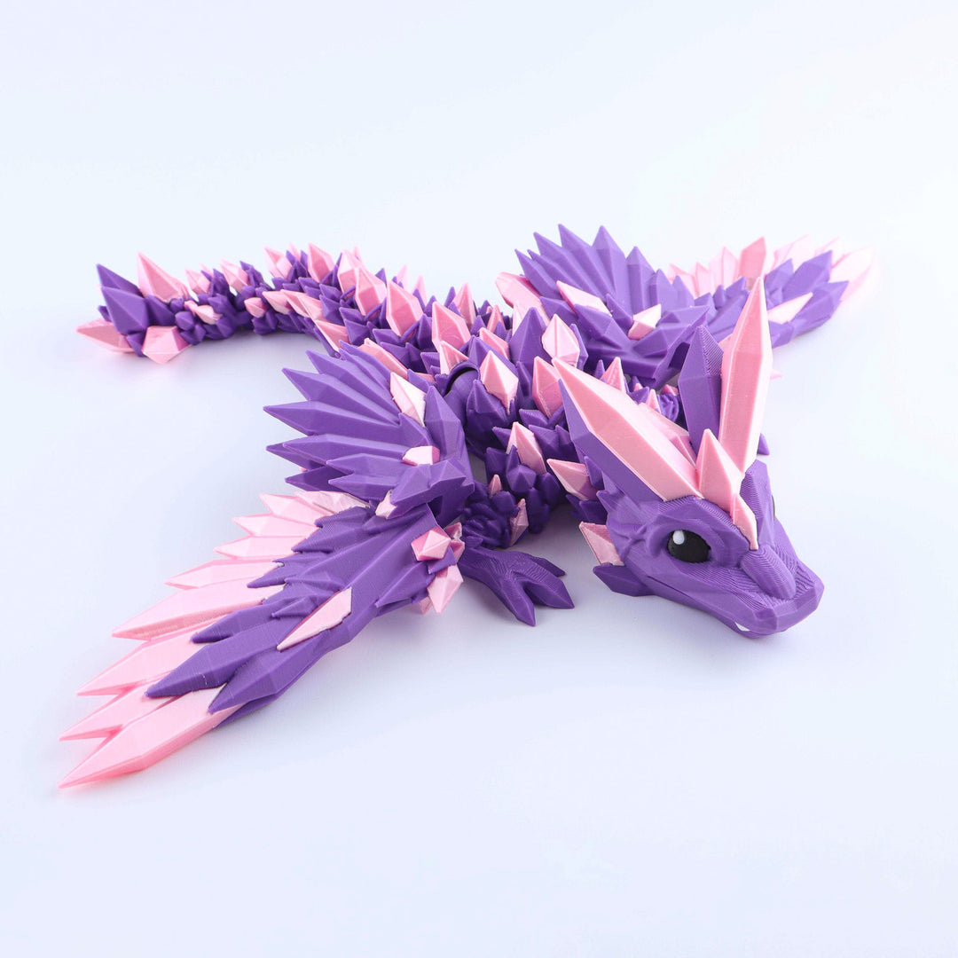 Purple and pink dragon toy figure on a white background