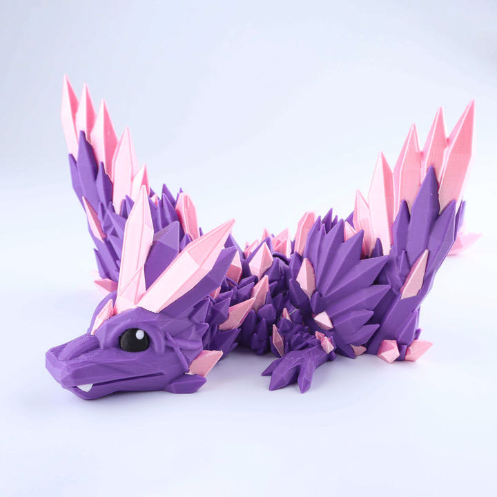 A 3D-printed articulated dragon figurine in purple and pink, shown from a side profile against a clean white studio background.