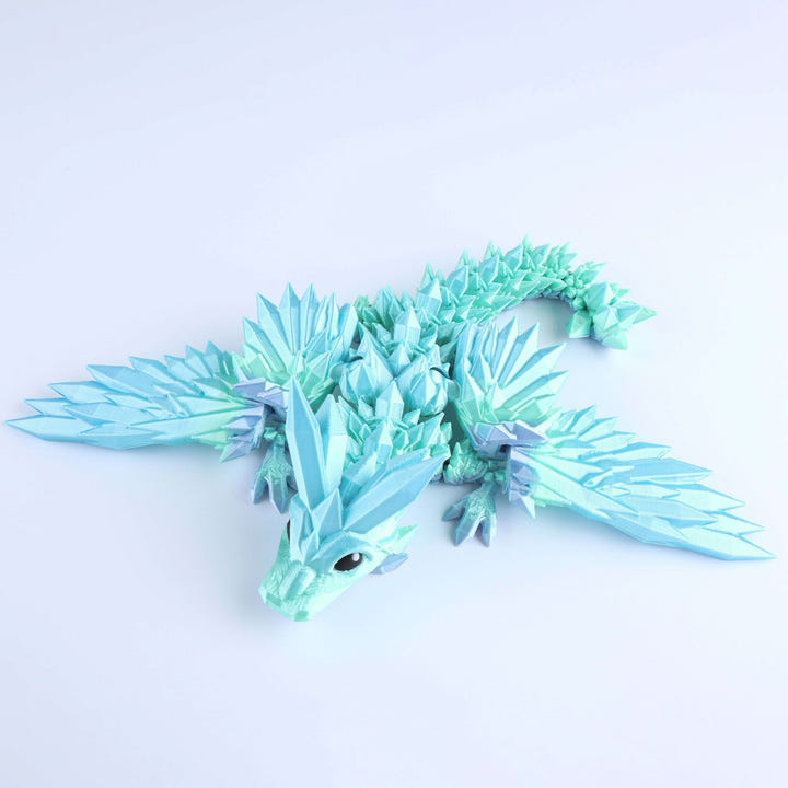 Toy dragon with a blue and green color scheme on a light purple background