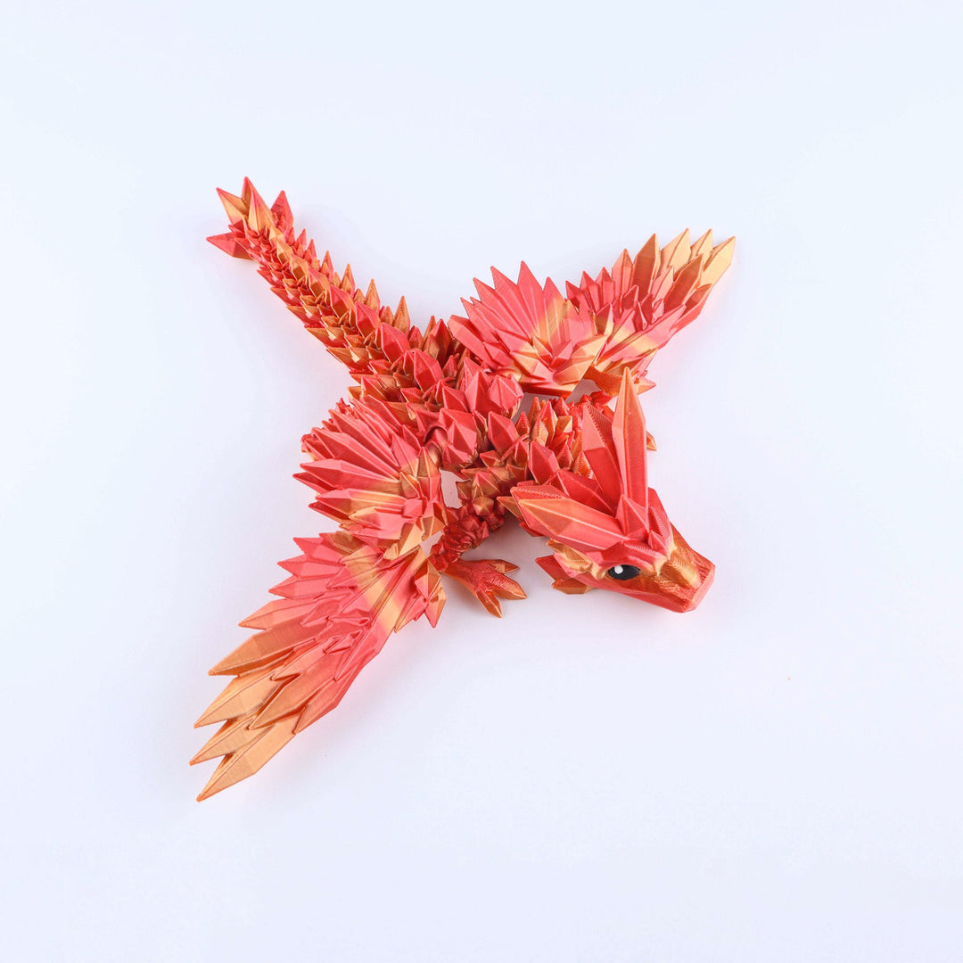 Red and orange dragon-like origami sculpture on a white background