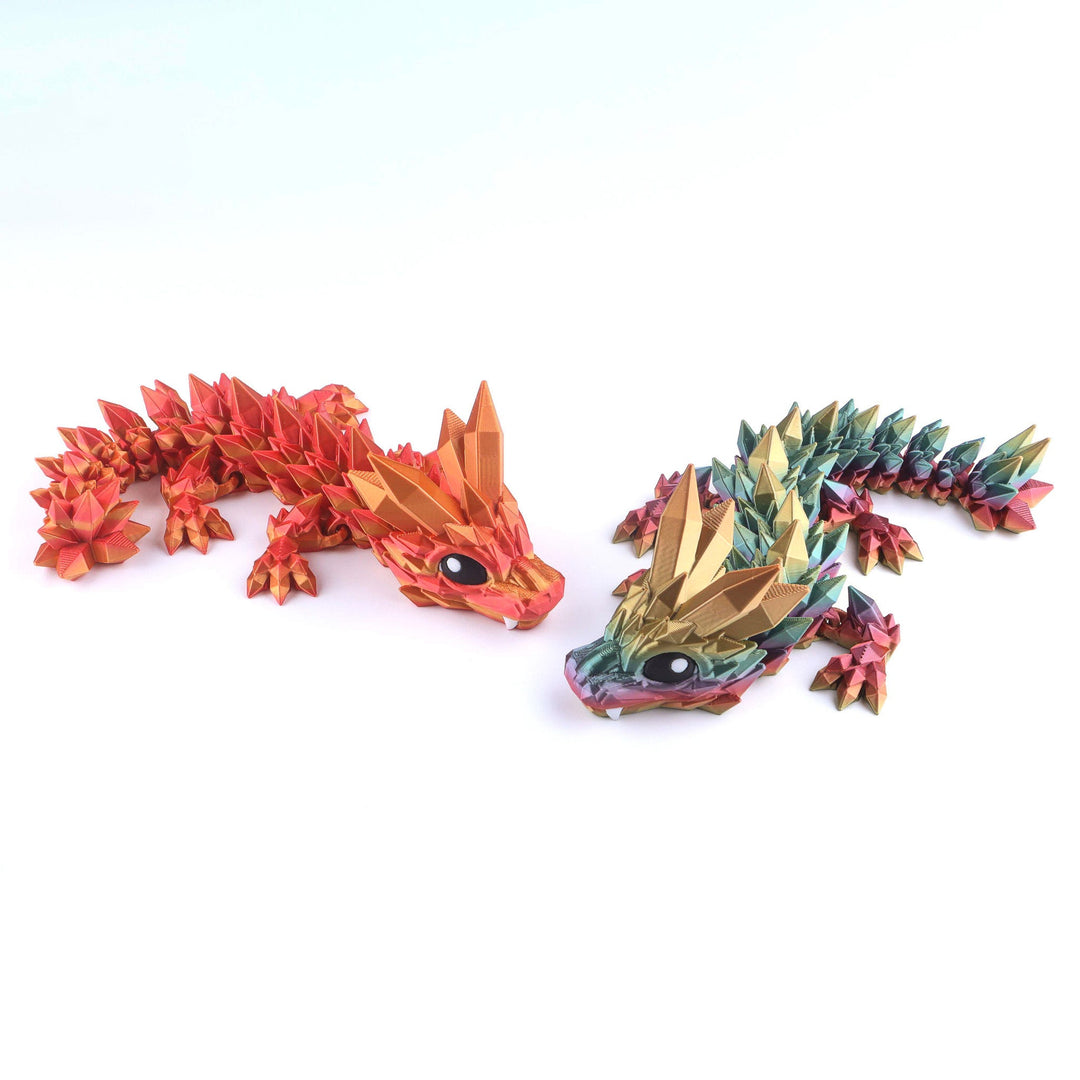 Two dragon figurines, one red and orange, the other multicolored, on a white background.