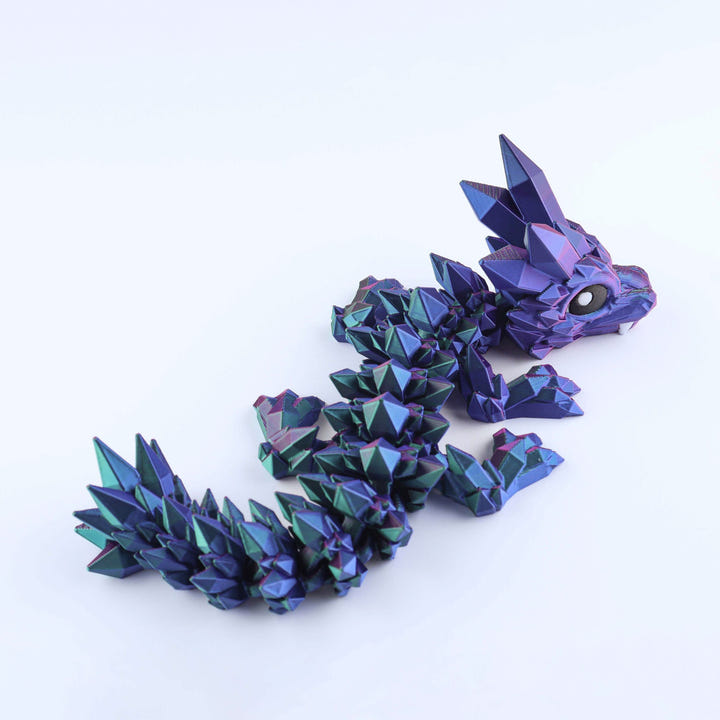 Blue and purple geometric dragon-like sculpture on a white background