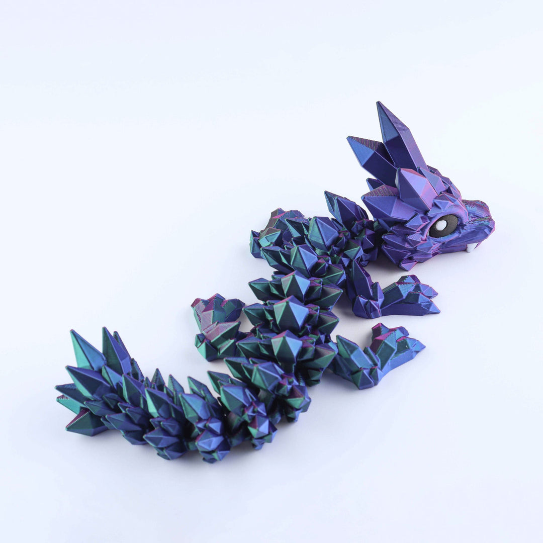 Blue and purple geometric dragon-like sculpture on a white background