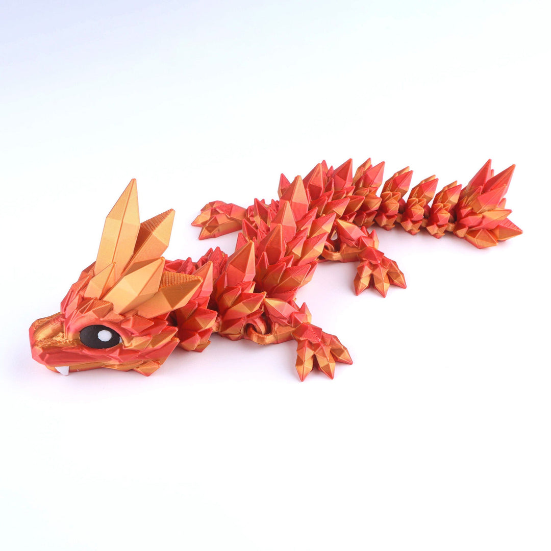 Red and gold dragon figurine on a white background