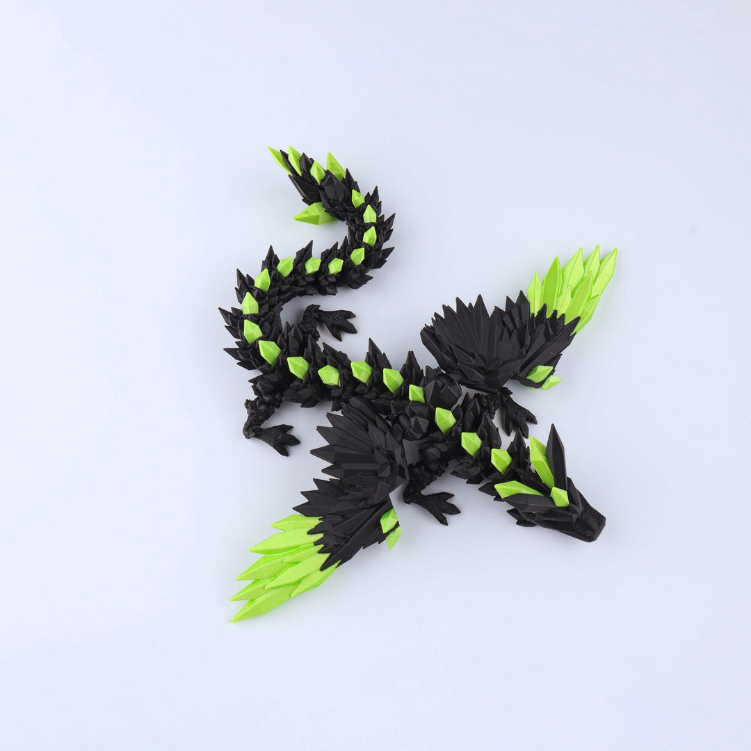 Black and green dragon toy on a light gray background