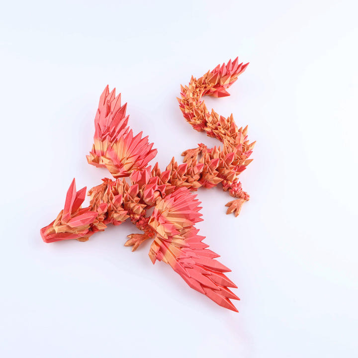 Red and orange dragon-shaped object on a white background