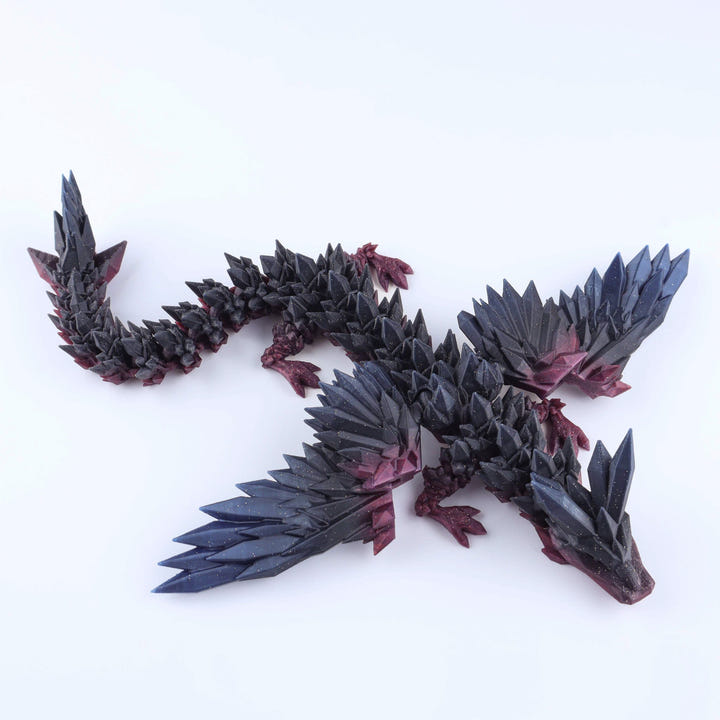 Black and red dragon-like creature figurine on a white background