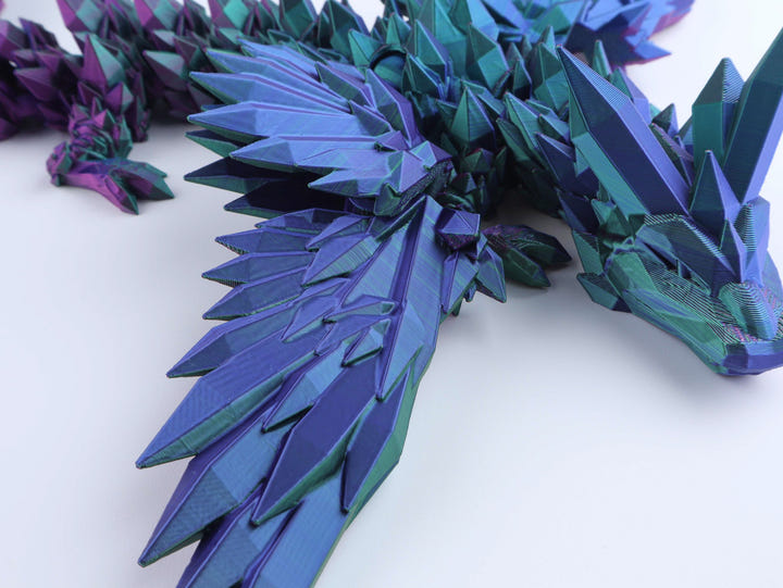 3D paper model of a dragon with blue and purple colors on a white background