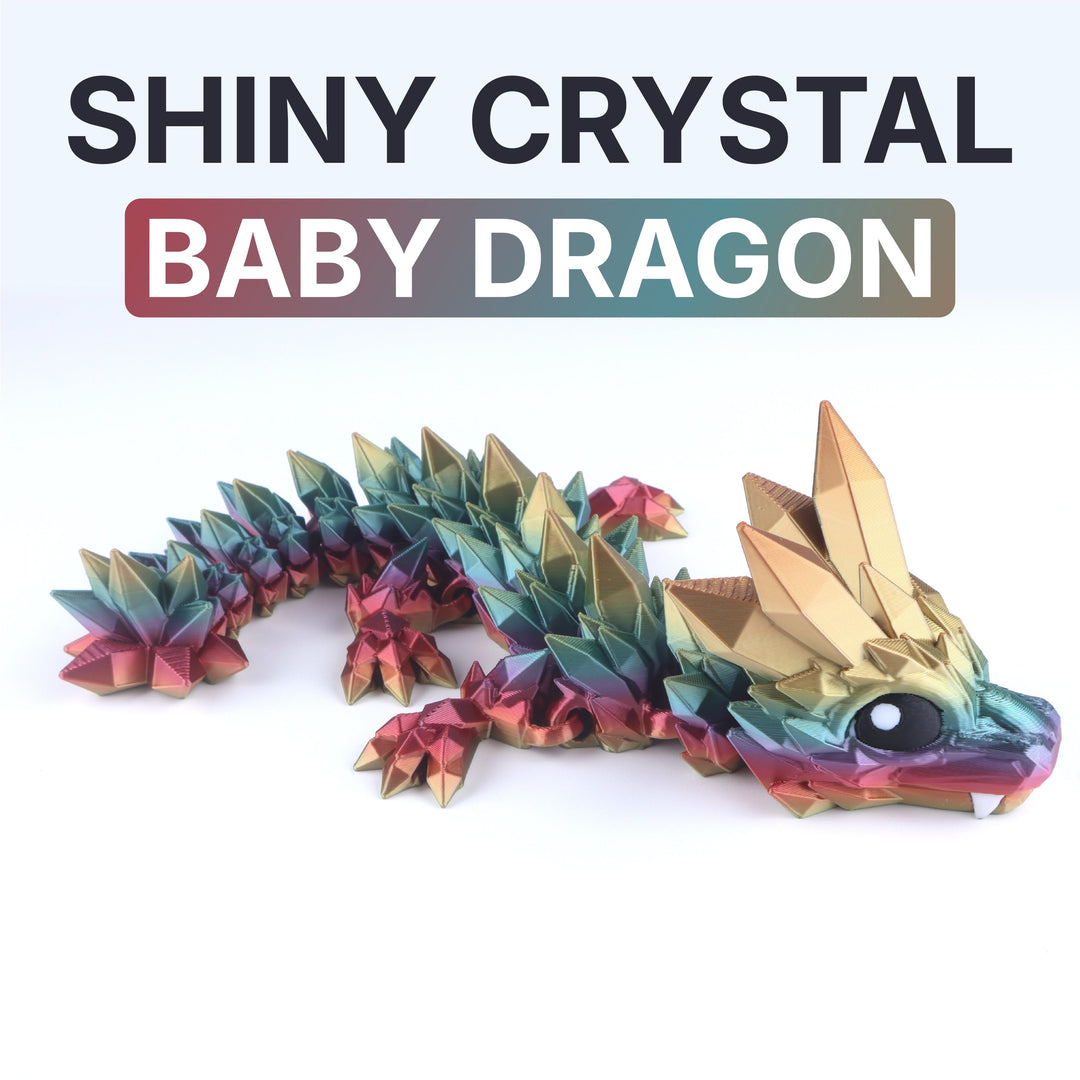 Shiny crystal baby dragon toy with colorful scales on a white background