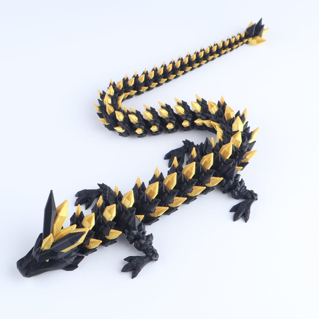 Black and gold dragon toy figure on a white background
