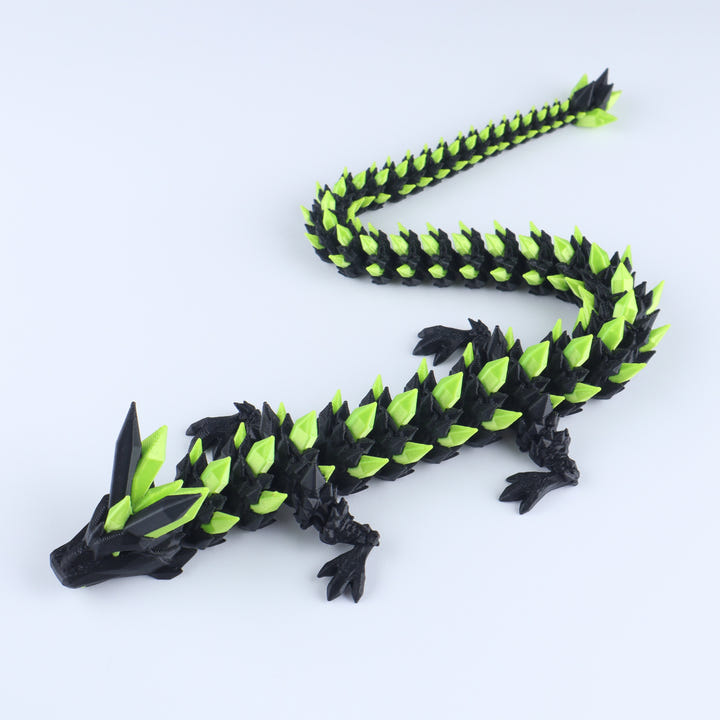Black and green dragon toy on a white background