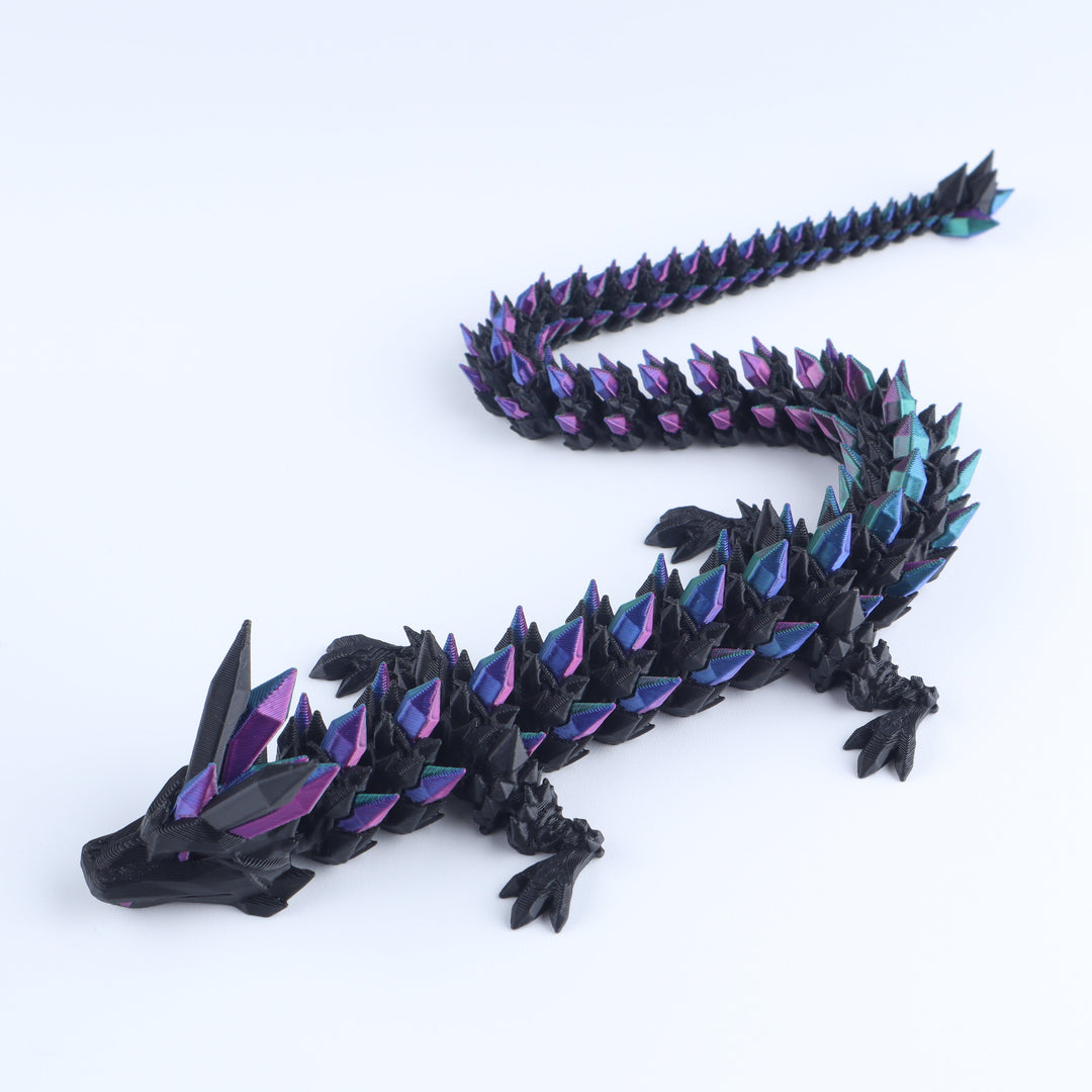 Black dragon toy with colorful spikes on a white background