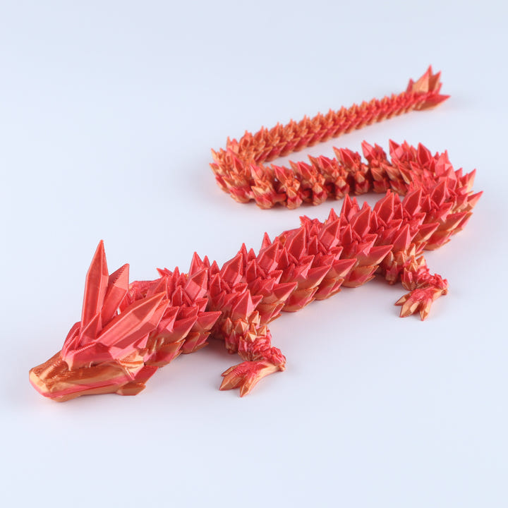 Red dragon-shaped origami sculpture on a white background