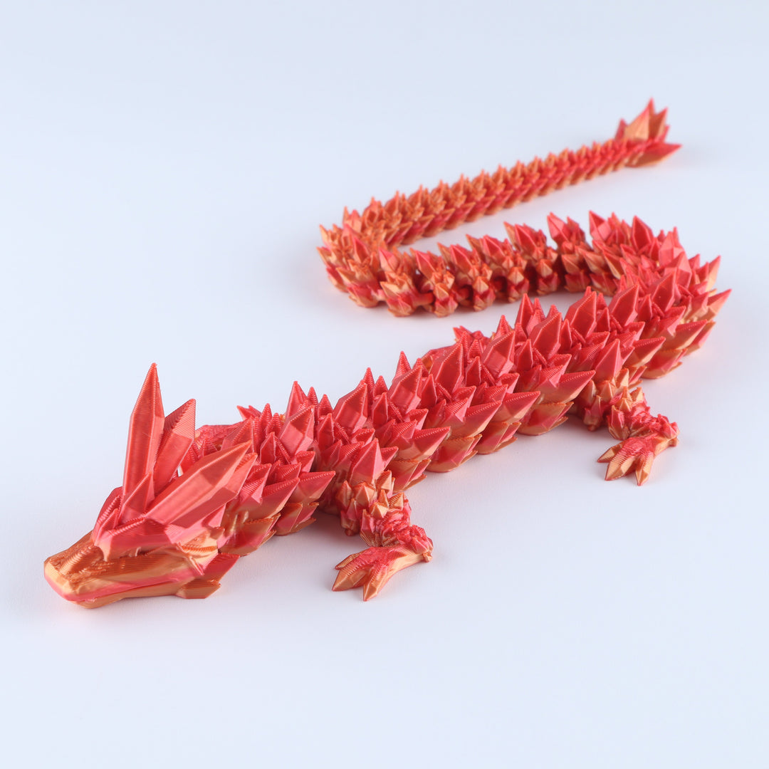 Red dragon-shaped origami sculpture on a white background