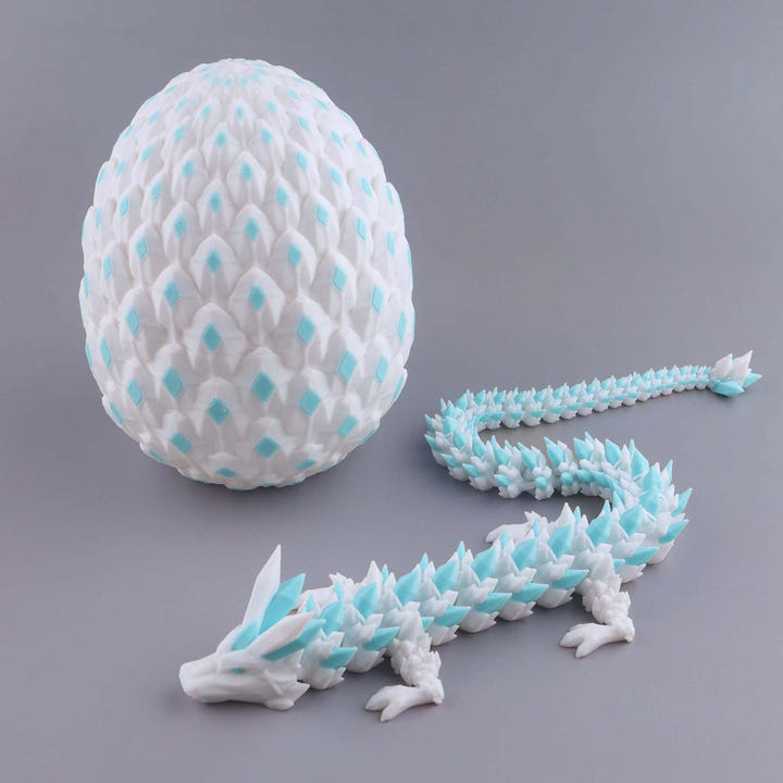 White and blue dragon egg with a dragon model on a gray background