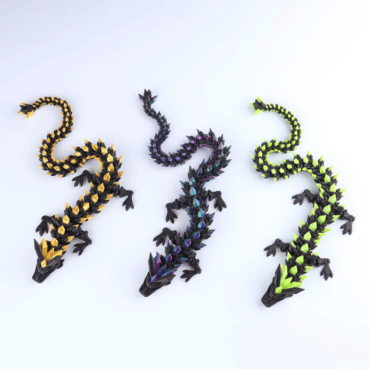 Three dragon-shaped figurines with colorful patterns on a white background