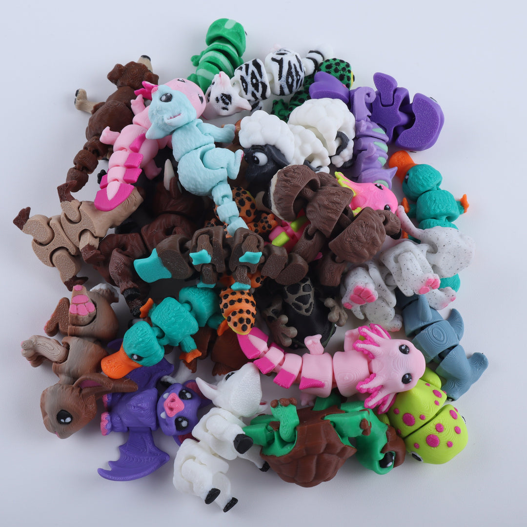 Assorted colorful animal figurines on a white background