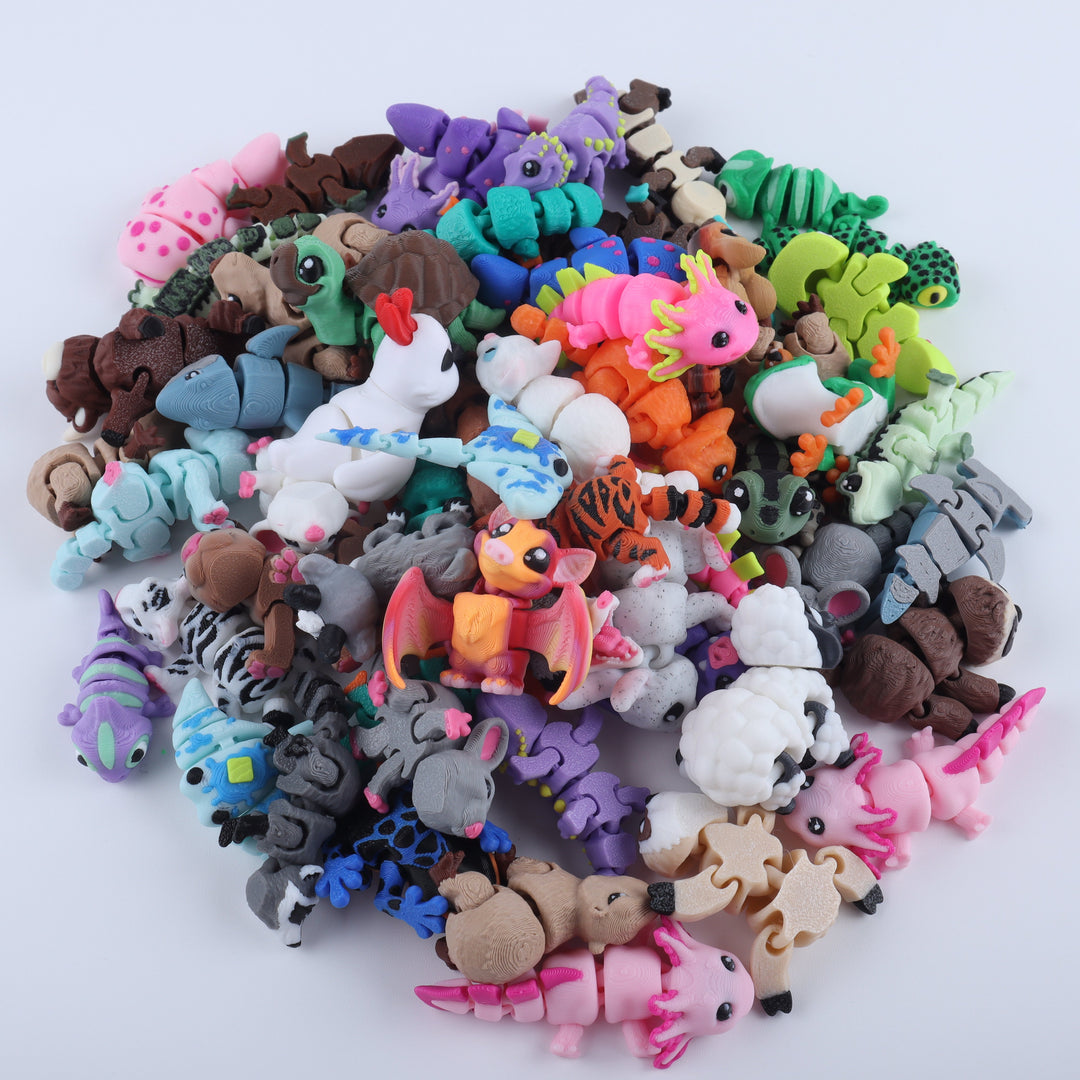 Assorted colorful animal figurines on a white background