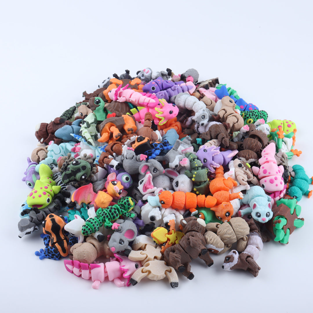 Assorted colorful animal figurines on a white background