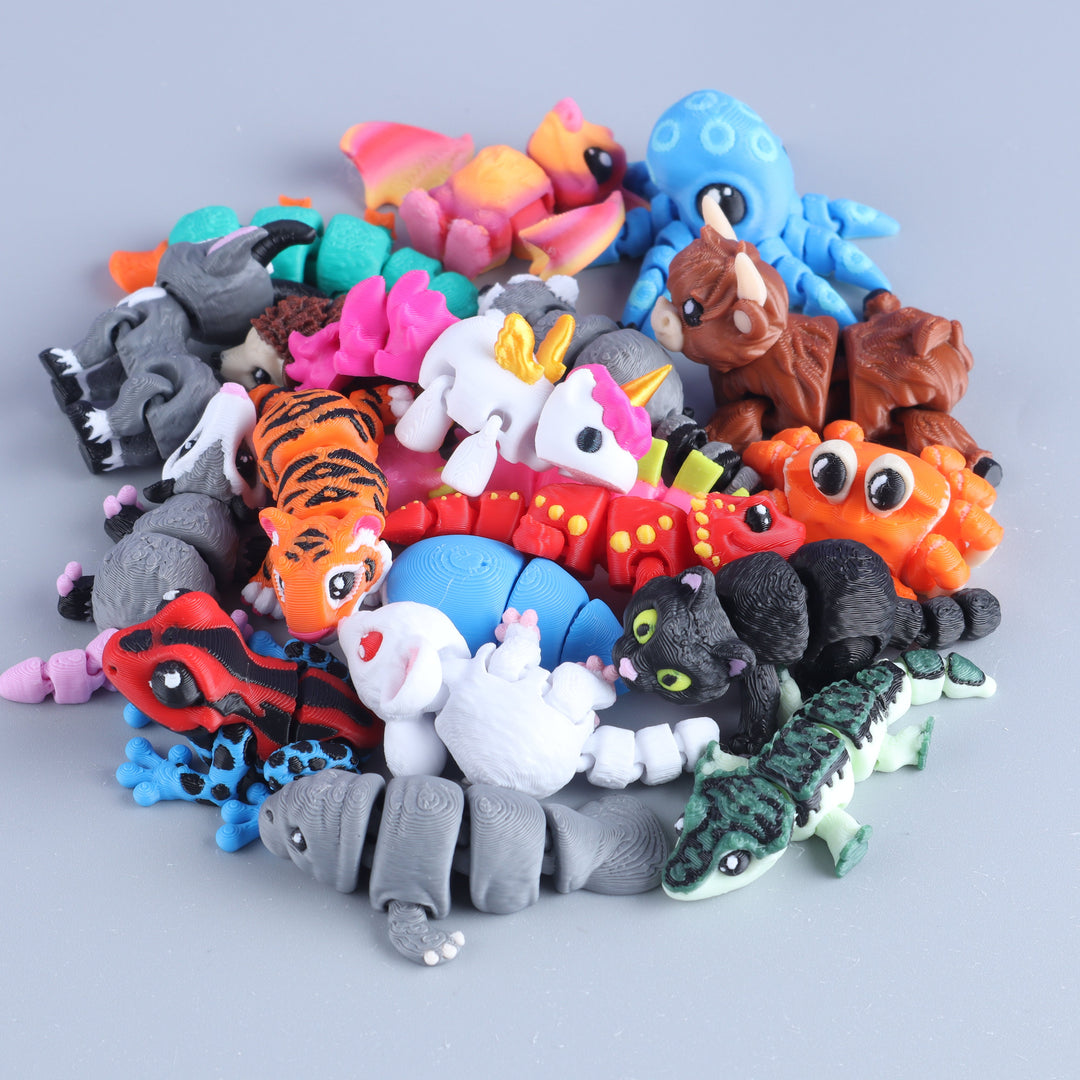 Assorted colorful animal figurines on a light gray background
