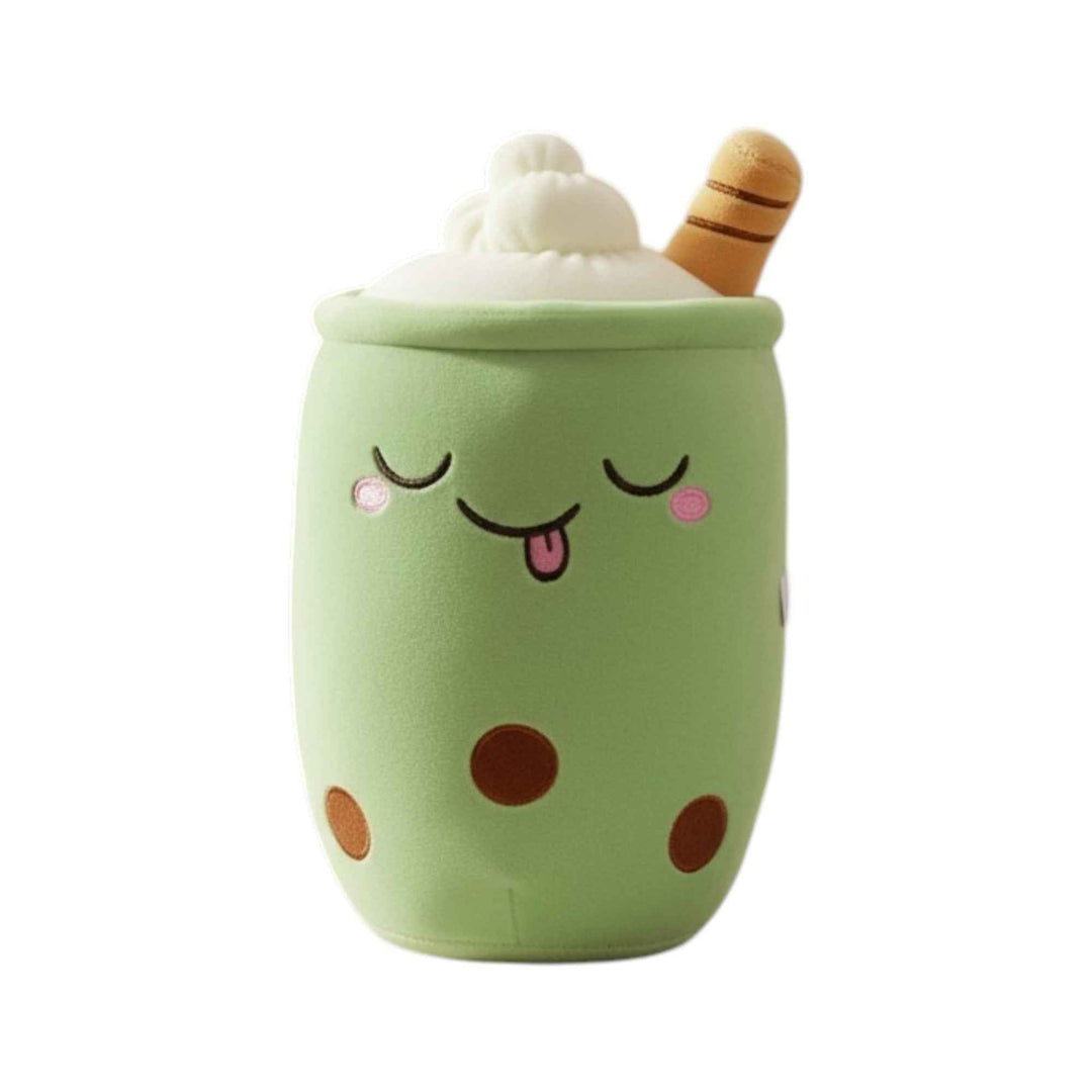 Plush toy resembling a green cup with polka dots and a smiling face, topped with whipped cream and a chocolate stick.