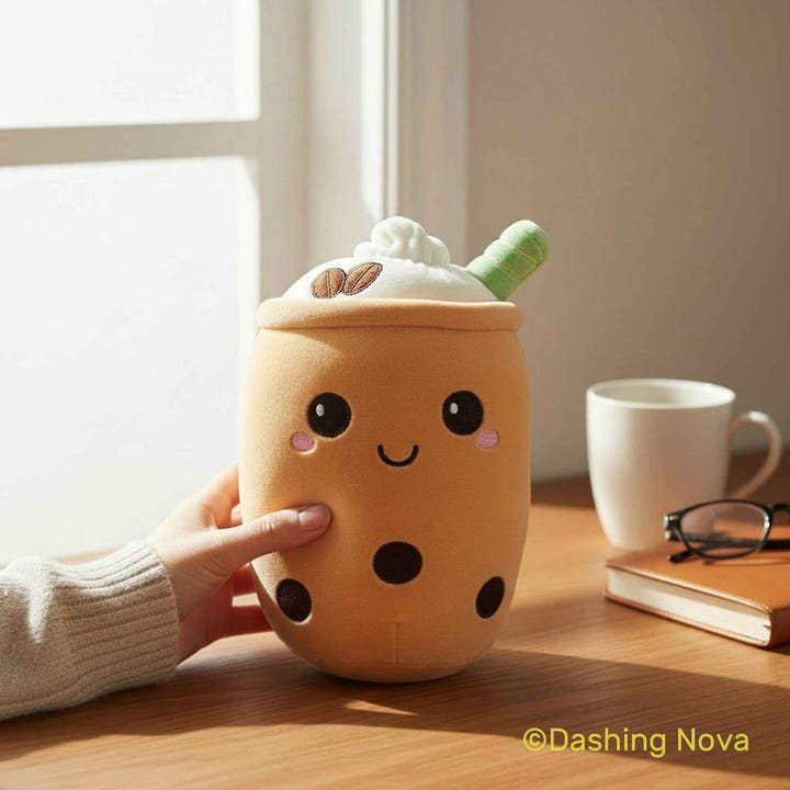 Plush toy shaped like a bubble tea cup on a wooden table with a window in the background.